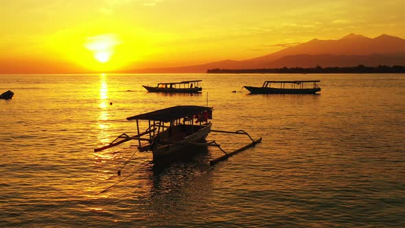 Beautiful Sunset View of the Horizon Over the Ocean, Boats are docked in the Foreground. Silhouette