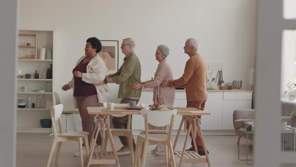 Senior People Dancing Conga at Home