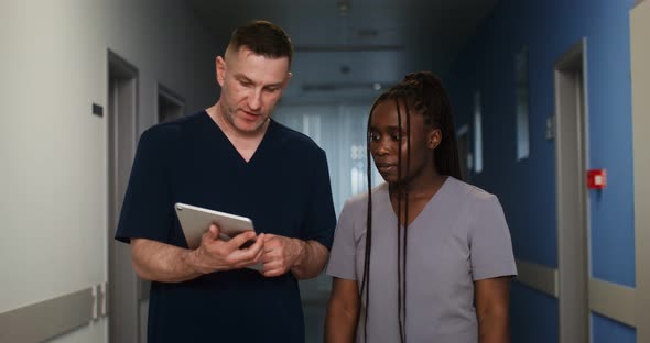 A Doctor Shows His Colleague Something on a Tablet Screen