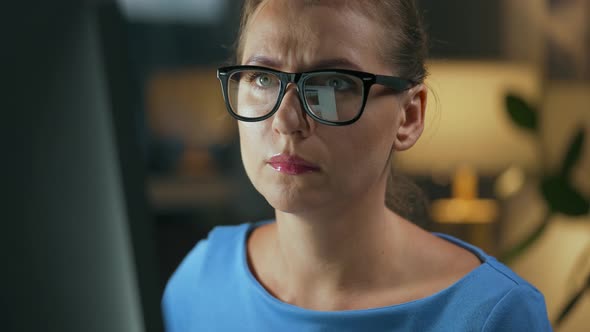 Woman in Glasses Looking on the Monitor and Surfing Internet