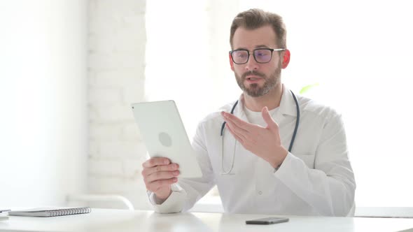 Doctor Making Video Call on Tablet in Office