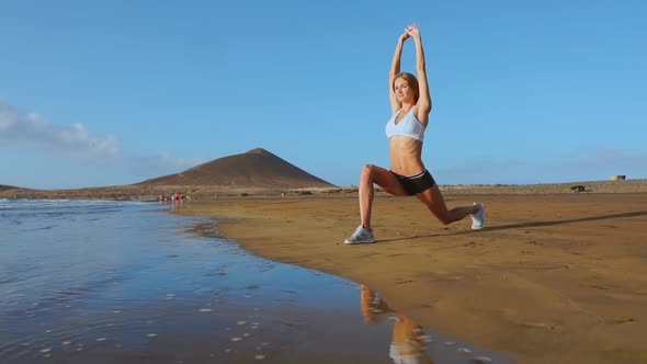 Yoga Retreat and Training - Woman in Yoga Pose at Beach at Sunrise