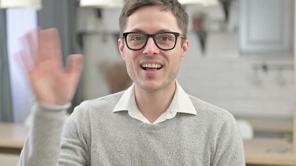 Young Man Waving at the Camera