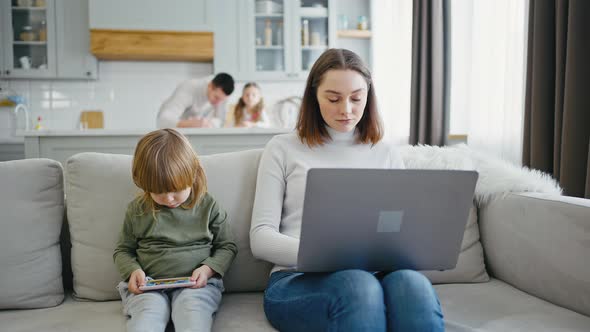 Self Isolated Woman Trying to Work at Home Her Family Spending Time on Background Slow Motion