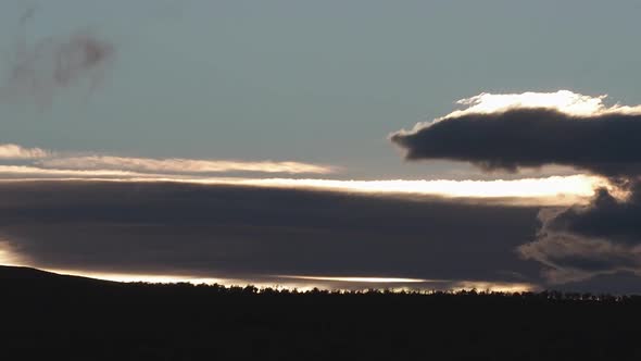 Time Lapse of the clouds above a forest during the sunset in Norway Scandinavia