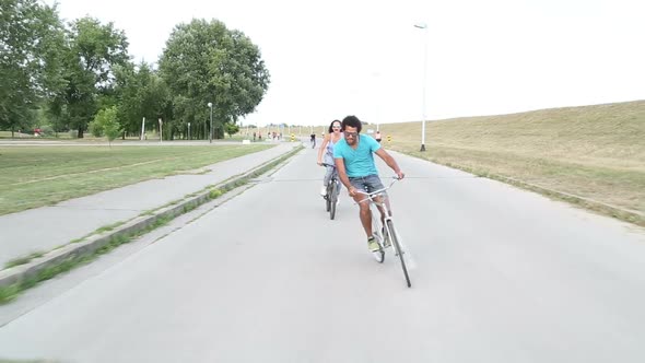 Group of friends having fun cycling and taking selfies with phone