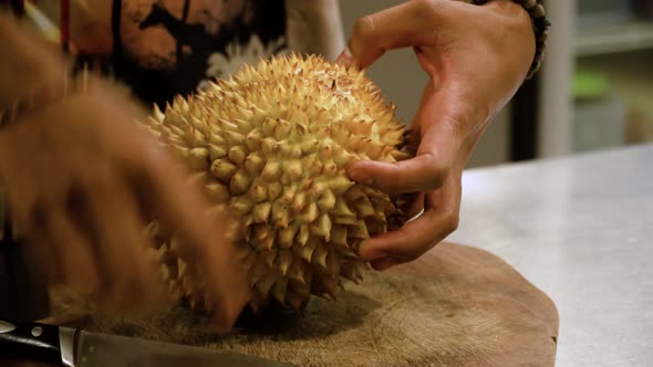 Man Trying to Peel Durian