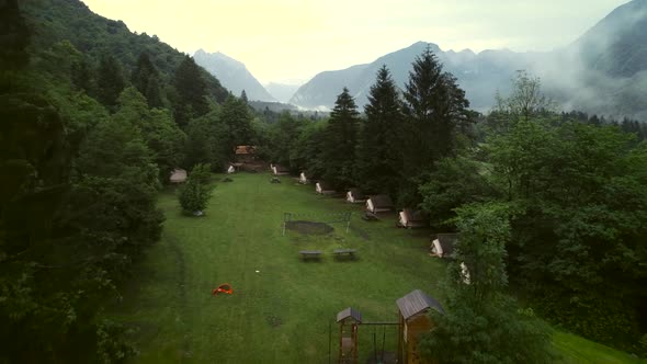 Aerial view of forest wooden cabins at an excursion camp in Soca river.