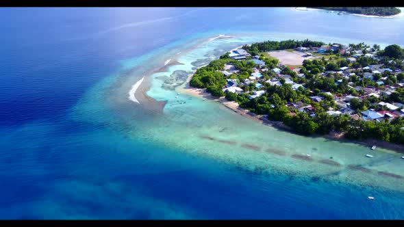 Aerial drone shot landscape of luxury bay beach adventure by aqua blue sea with white sandy backgrou