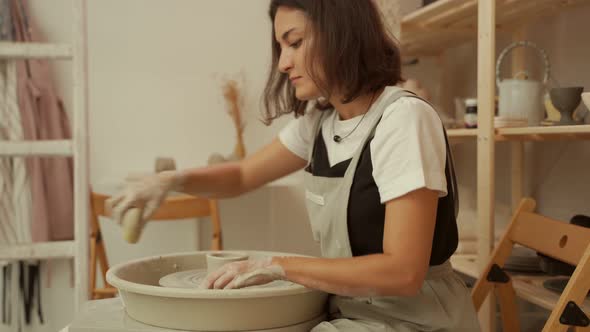 Woman Working at Pottery Wheel in Studio
