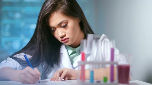 Medium Closeup Young Female Science Researcher During Working at Laboratory in Hitech Background