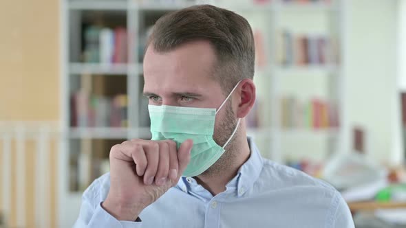 Portrait of Young Man with Face Mask Coughing