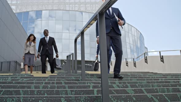 Colleagues Walking on Stairs Outside of Office Building