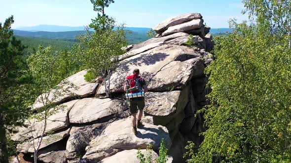 View of a Tourist Photographer Climbed to the Top of the Mountain to Take a Photo