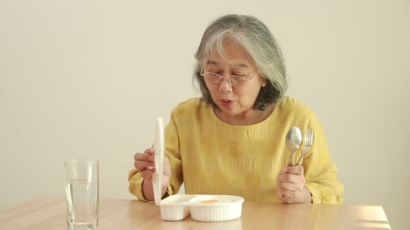 Asian elderly woman Stay at home during the coronavirus pandemic.