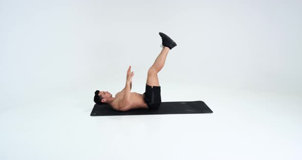 Young Man Making Abdominal Exercises. Leg Movement