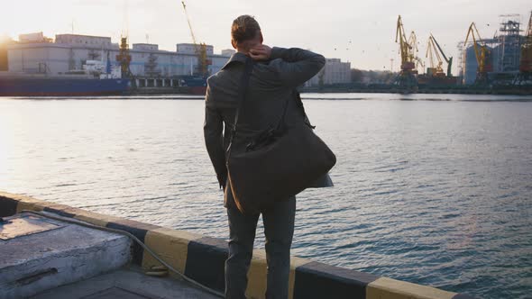 Young Stylish Redhead Handsome Hipster Man on Sea Port Background During Sunset