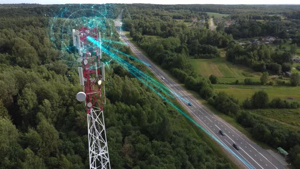 Antenna of communication tower transmits signals to self-driving cars on a suburban highway.