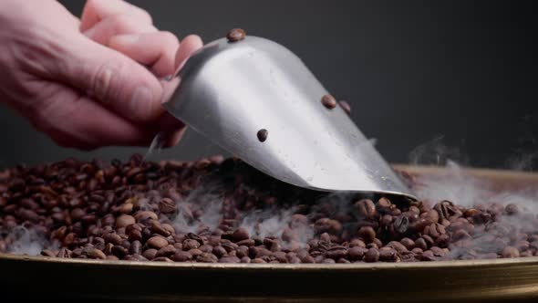 Man Hand Holding Ladle Scooping Coffee Seeds Close Up