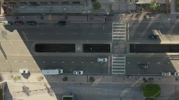 AERIAL: Young Man Laying on Street Slow Birds Eye View Flight Over Downtown Los Angeles California