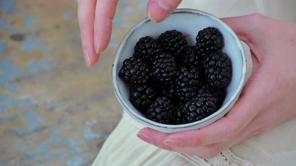 Woman Holding Bowl of Blackberries