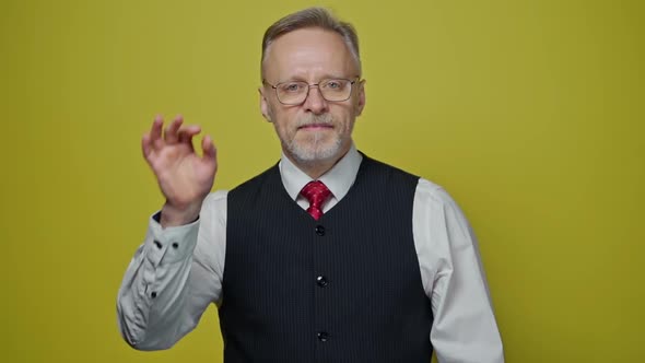 Portrait of man on yellow background. 