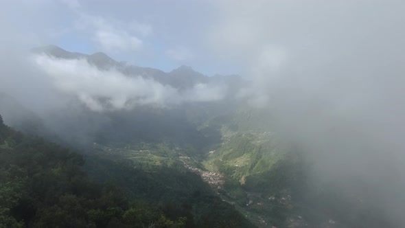 Drone flying in the clouds over the valley on Madeira island, Portugal