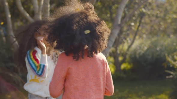 Two African Little Sisters Having Fun Together at Park Showing Tongue To Each Other.