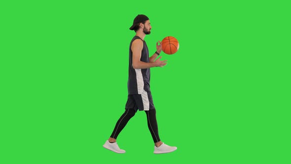 Basketball Player Walking with Ball in Hands on a Green Screen Chroma Key