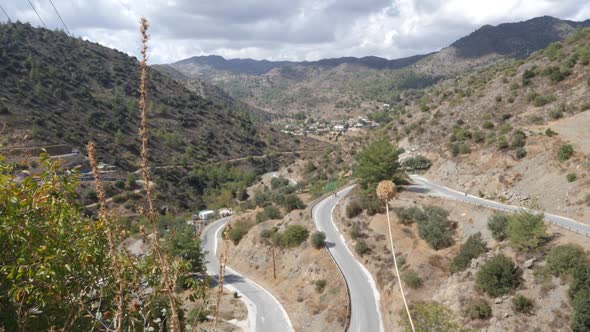 Wide high angle view of two people hiking on a winding mountain path