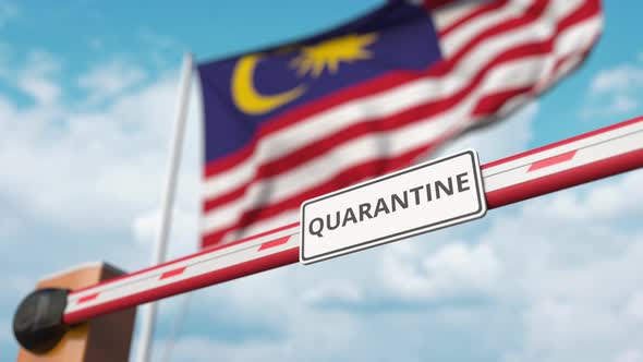 Barrier Gate with QUARANTINE Sign Opens at Flag of Malaysia