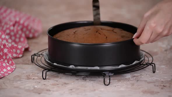 Removing chocolate cake from a baking form.	