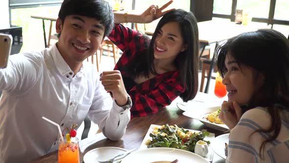 Young Asian People Taking Selfie Photos and Having Lunch Together at Restaurant