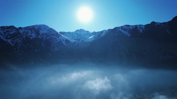 Sunrise at Andes Mountains near Santiao Chile. Foggy morning.