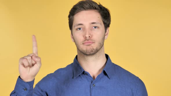 No, Rejecting Casual Young Man on Yellow Background