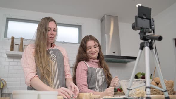 Mother and daughter live stream while cooking in the kitchen