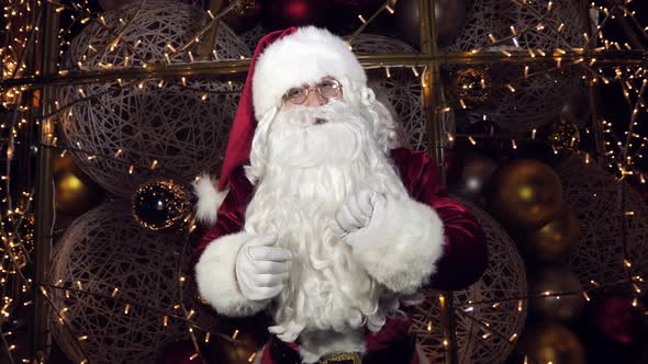 Funny Santa Claus is Talking to the Camera Wishing a Merry Christmas and a Happy New Year