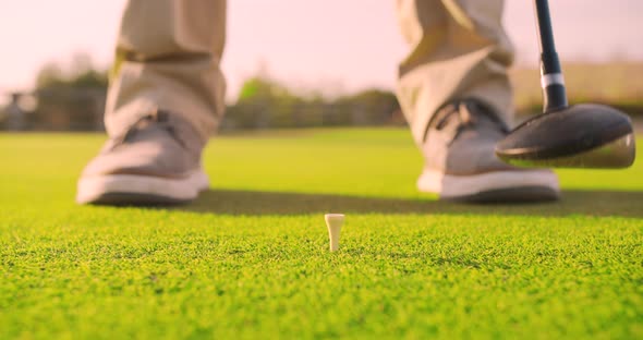 Man Play Golfing And Putting Ball In Hole. Close-up.