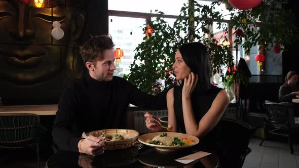 Man and Woman Talking in a Thai Cafe