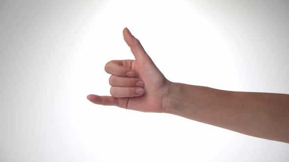 A Woman's Hand Shows the Greeting of Surfers the Thumb and Little Finger Protruded Shaka