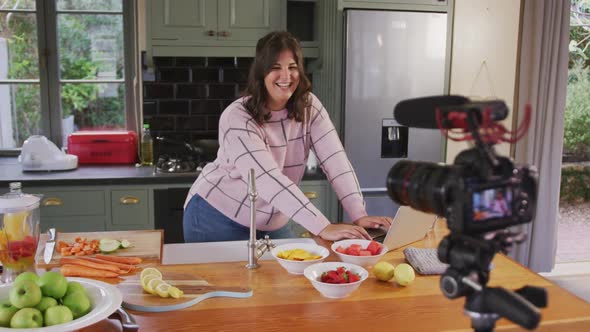 Caucasian vlogger woman doing a cooking video at home