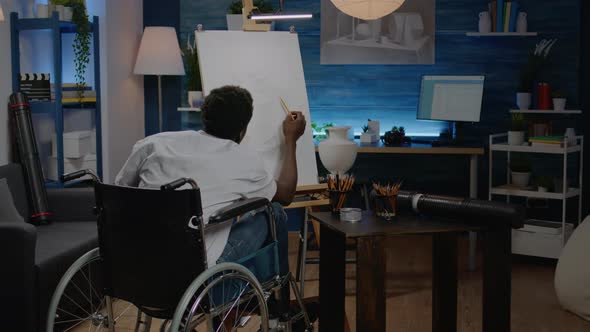 Black Young Artist with Handicap Drawing Vase on Canvas