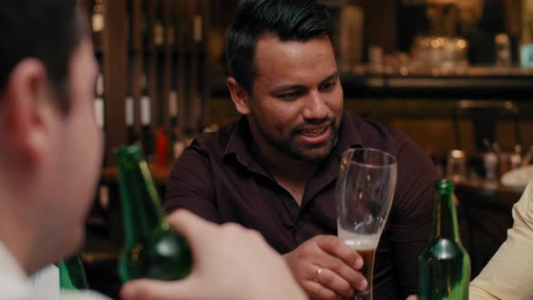 Men talking and drinking beer in the pub