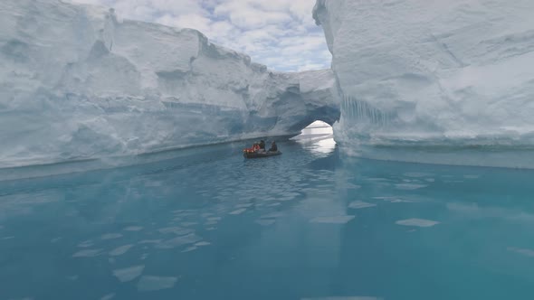 Floating Boat Among Icebergs in Ocean. Antarctica.