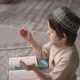 Muslim little boy reading the Koran in prayer hat and arabic clothes with rosary beads - VideoHive Item for Sale