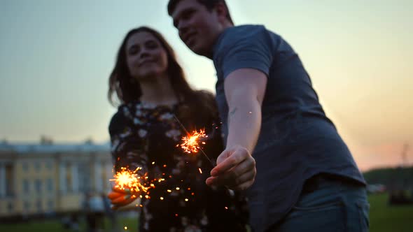 The Couple, Male and Female, Kissing with Bengal Light Sticks.