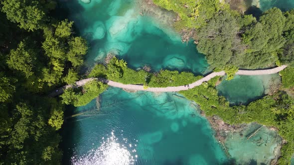 Take off over the Plitvice Lakes National Park with many green plants and beautiful lakes, a mountai