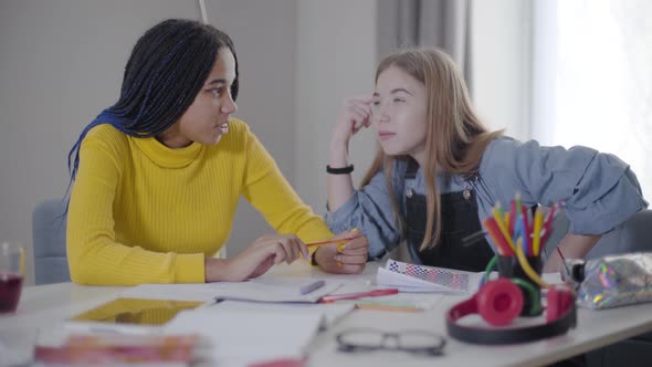 Pretty Caucasian Girl Emotionally Telling Something To African American Friend. Happy Students