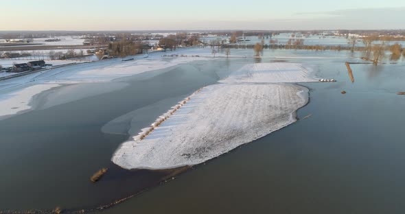 Aerial view of snow-covered island in flood plains of river IJssel, Netherlands.