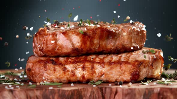 Super Slow Motion Shot of Seasoning Falling on Grilled Double Beef Meat on Wooden Board at 1000Fps